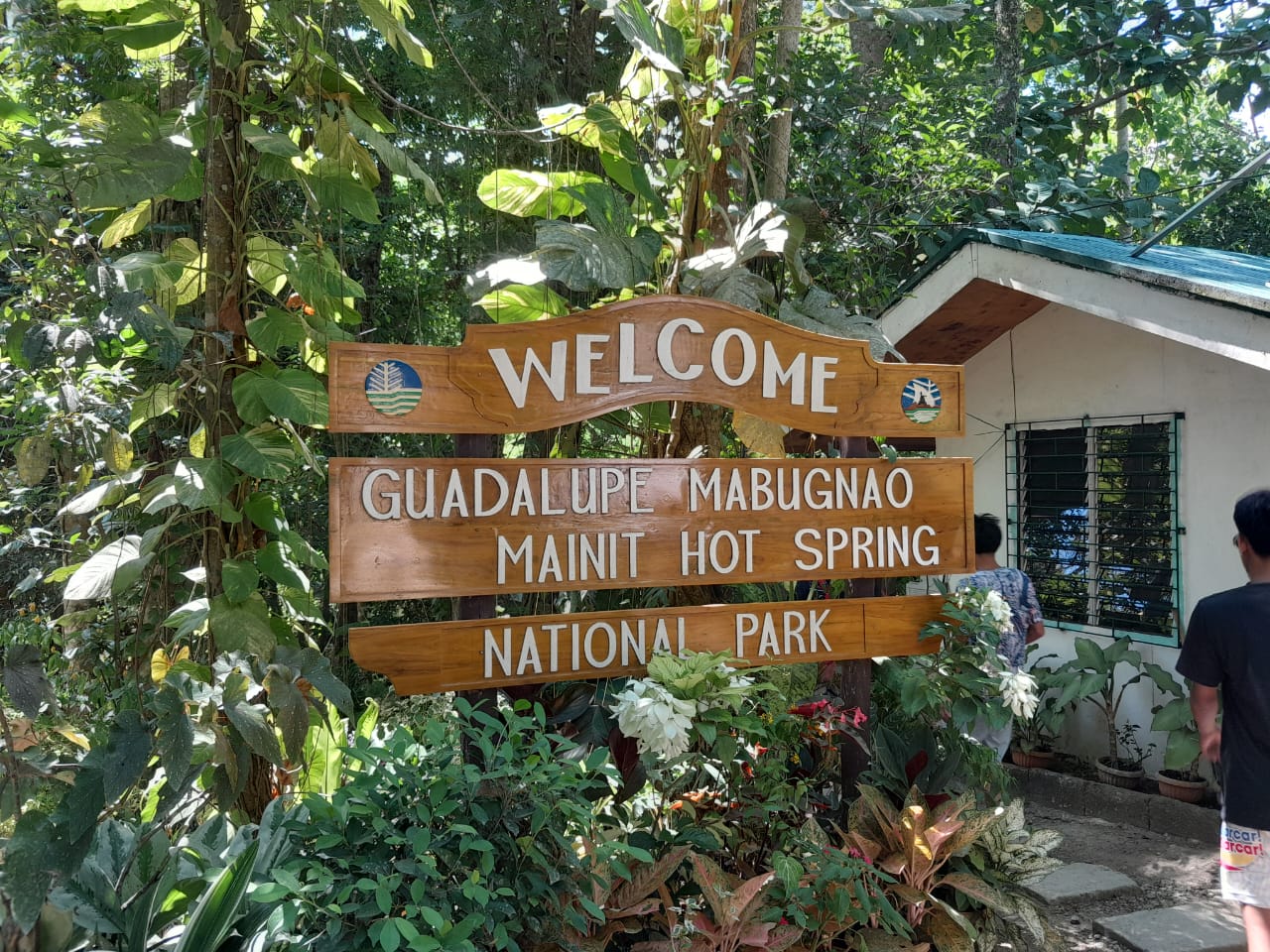 A sign welcomes you to the Guadalupe Mabugnao Mainit Hot Spring after paying the entrance fee.